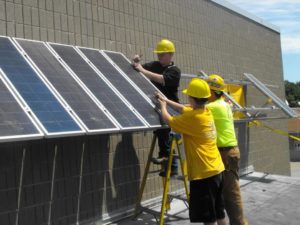 Workers installing solar panels.
