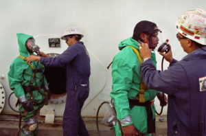 Refinery contractors prepare to enter a drained fuel tank to inspect welds. Photo by Earl Dotter. Used with permission. 